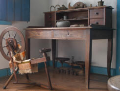 antique desk and spinning wheel